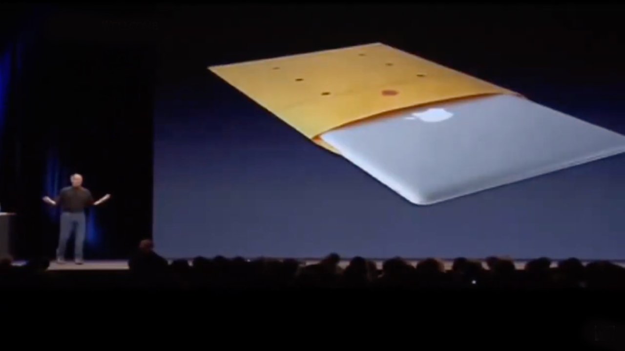 Steve Jobs on stage in 2008, showing an image of the MacBook Air in an envelope