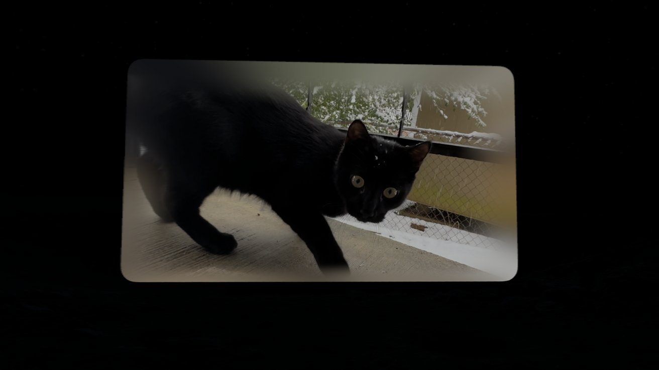 A black cat with yellow eyes outside with snow falling in the background