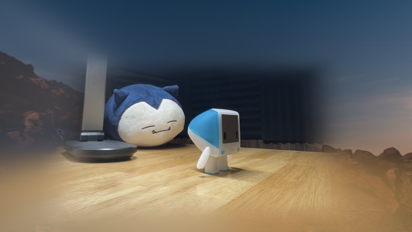 A Bondi blue iMac toy on a desk