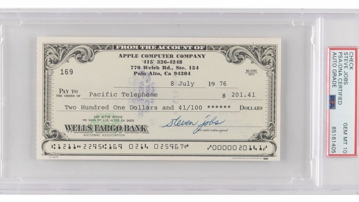 A vintage Apple Computer Company cheque from 1976, signed by a company co-founder, encased in a protective grading case.