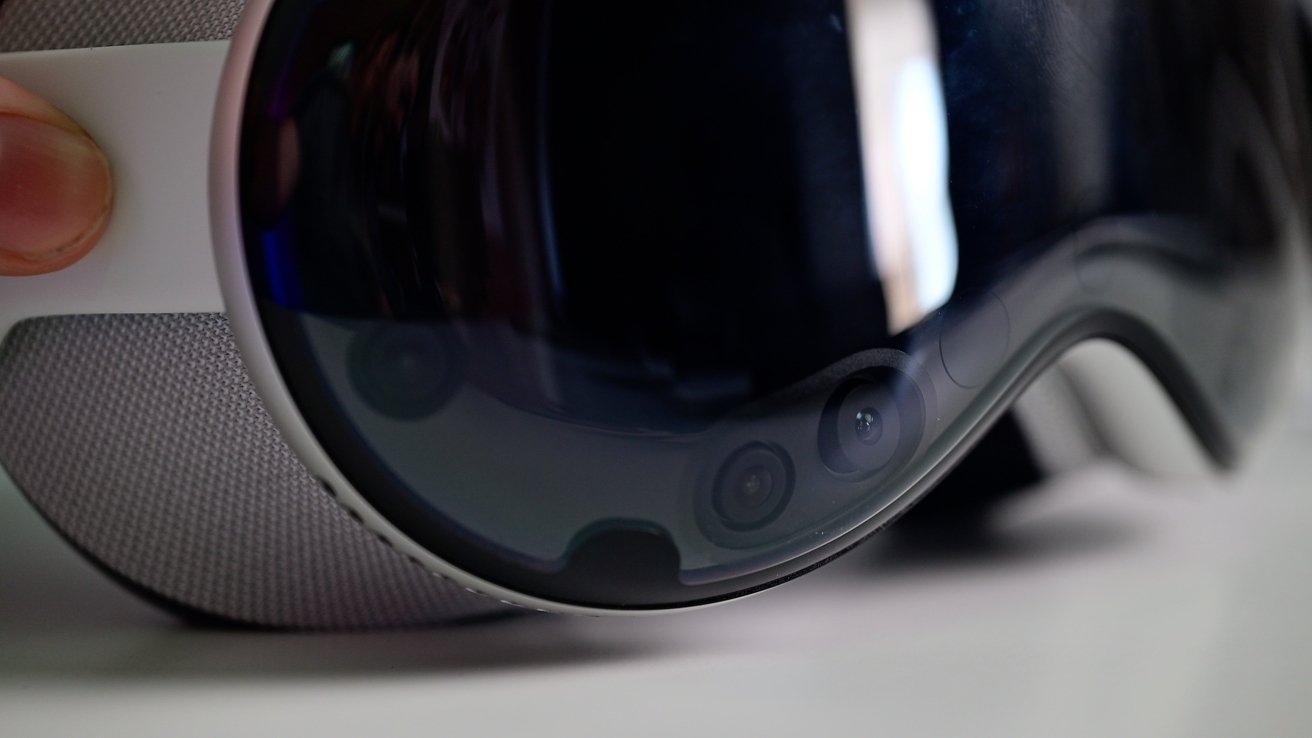 Close-up of Apple Vision Pro showing lenses and sensors with a blurred background.