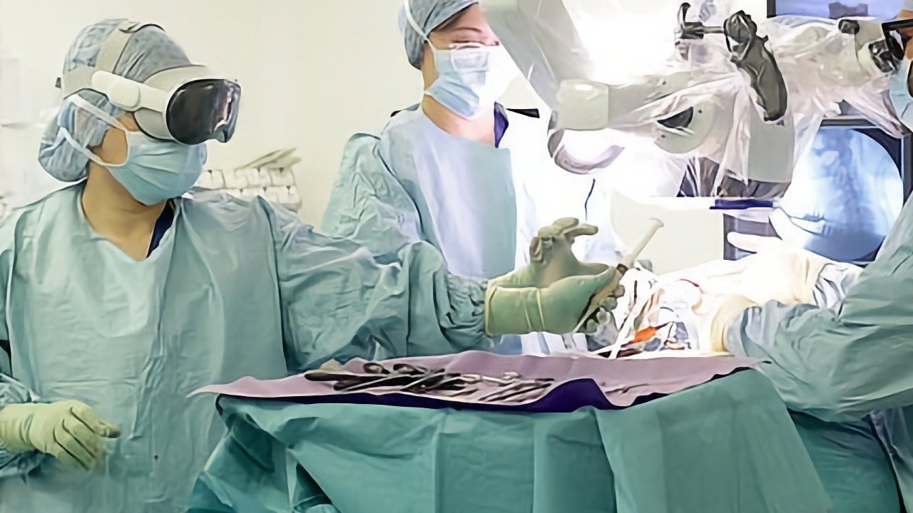 Surgeons in scrubs and masks operating with modern equipment, one wearing a head-mounted device, a tray with instruments in the foreground.