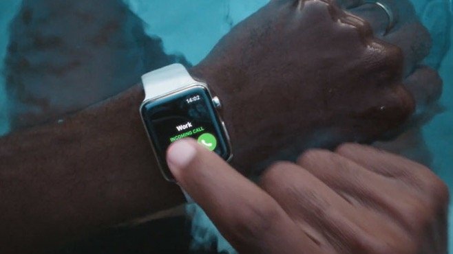 Man answering a phone call on his Apple Watch while in a pool