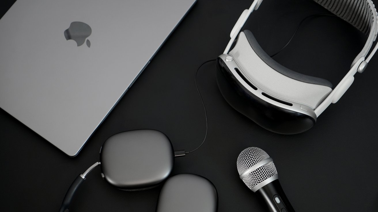 A MacBook Pro, Apple Vision Pro, AirPods Max, and microphone on a desk