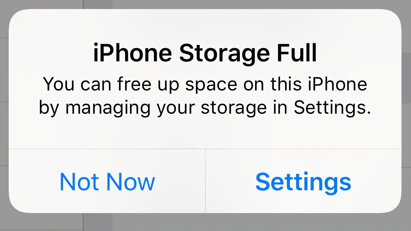 A pop up message saying 'iPhone Storage Full' with options to go to Settings or delay