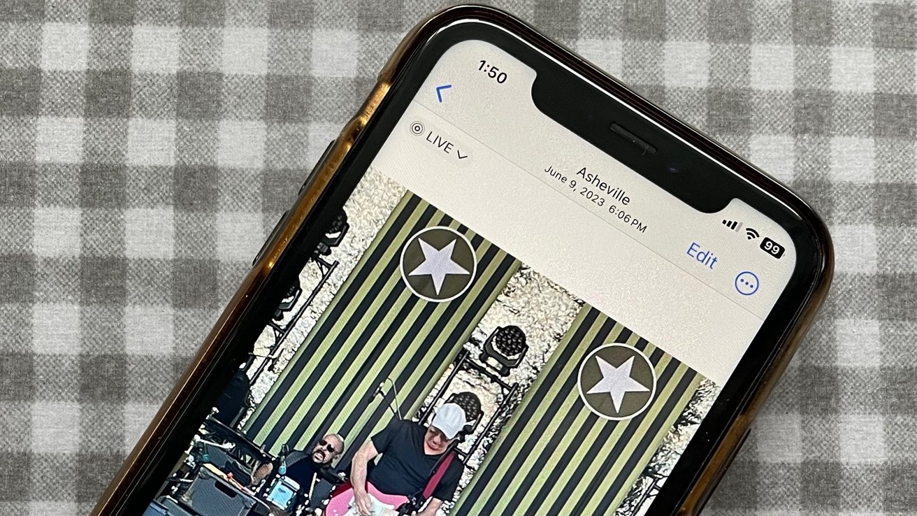 iPhone on checkerboard background showing musician in a Live Photo in the Photos app