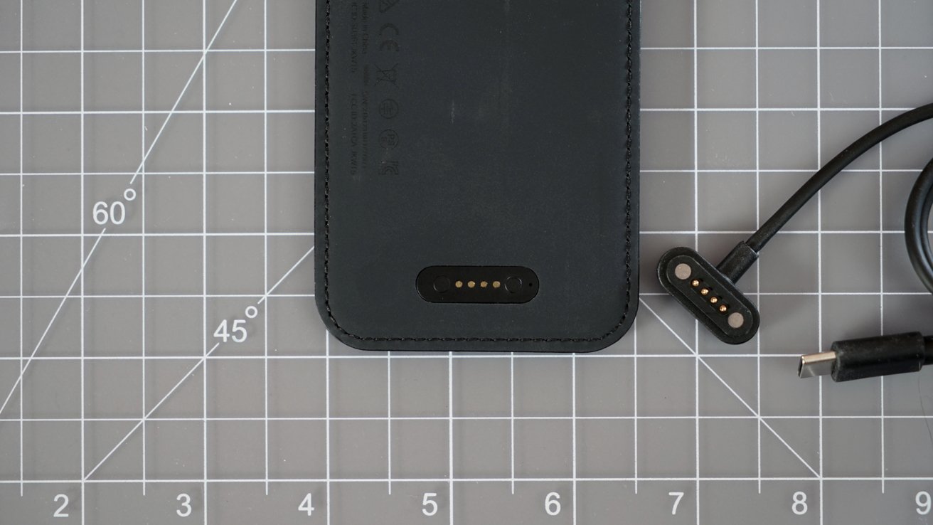 The base of the Loc8 Wallet showing the charging pad next to the charging cable
