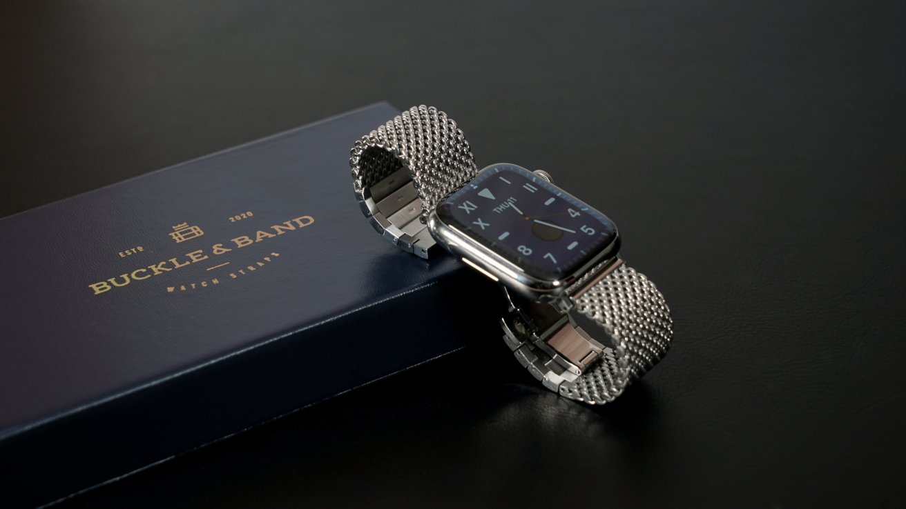 Silver metal Apple Watch band next to Buckle and Band box.