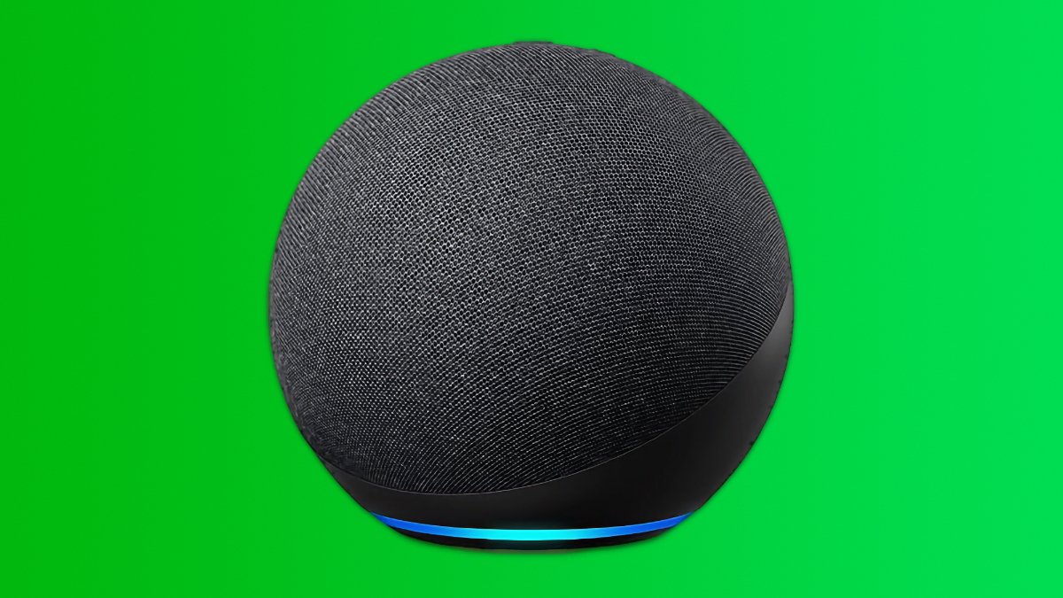 An Amazon Echo smart speaker with a blue light at the base on a bright green background.