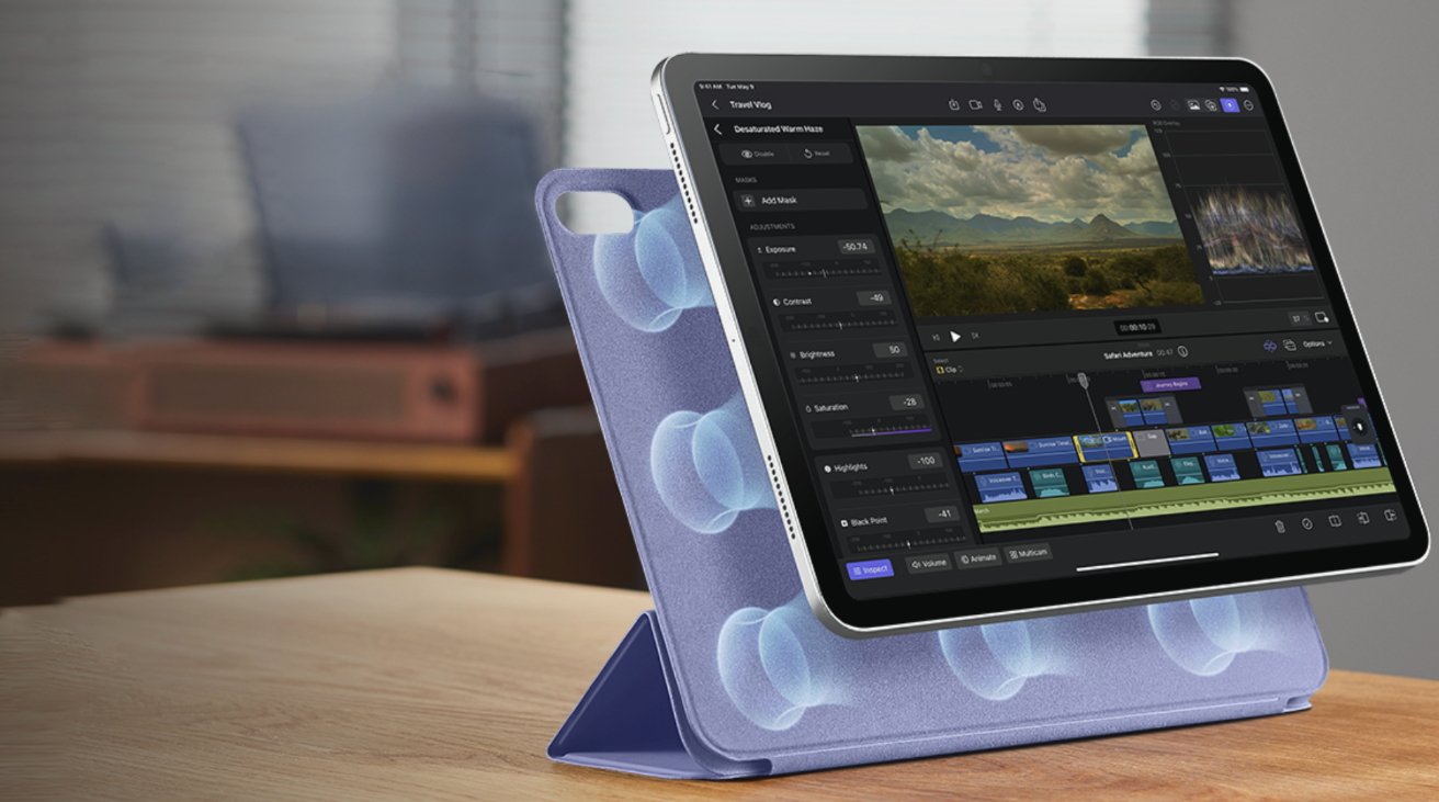 Tablet with video editing software open on a stand with a blurred background of a room.