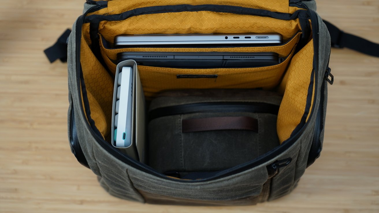 Inside the Air Porter Backpack, orange interior, MacBook, iPad, keyboard, and Shield Case inside.