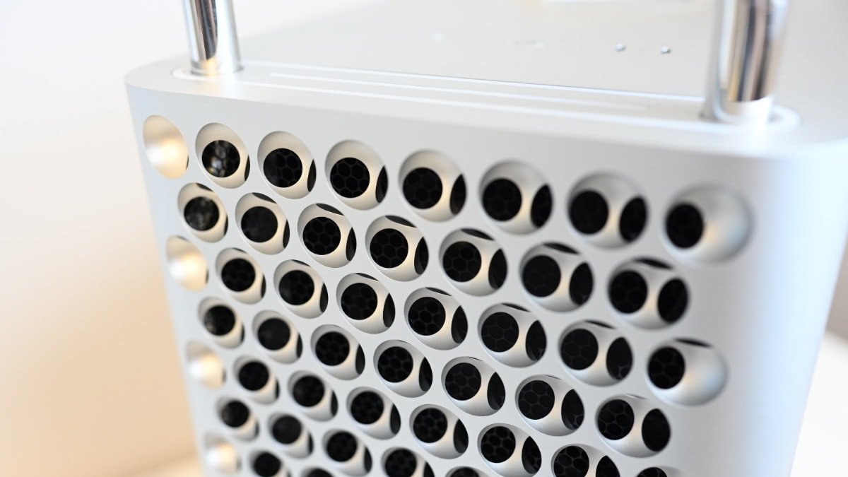 Close-up of a Mac Pro with a grid of circular holes showing internal hexagonal structures, likely a computer case.