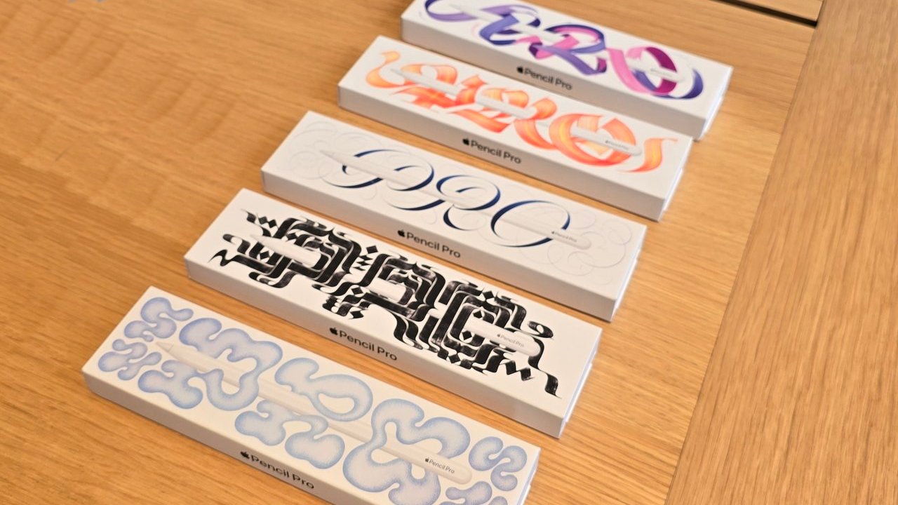 Five boxes with intricate designs on a wooden table, each labeled 'Pencil Pro' in different artistic styles.