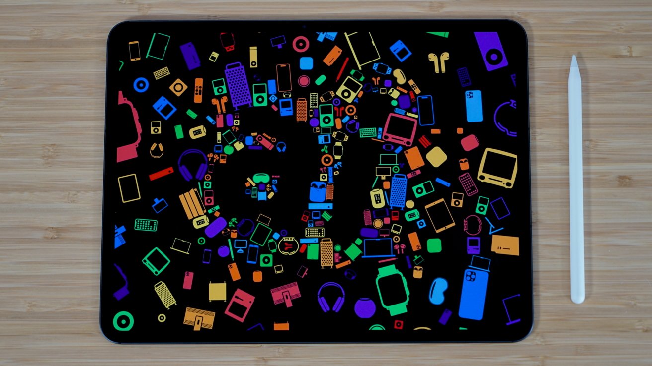 An iPad Pro with a colorful wallpaper featuring many Apple gadgets surrounding the letters 'ai'