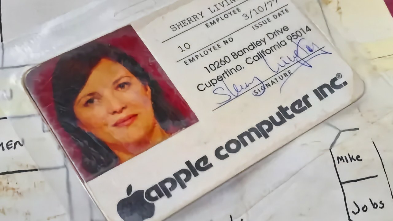 Faked vintage Apple Computer Inc. employee badge with a woman's photo, signature, and company logo, surrounded by other aged documents.