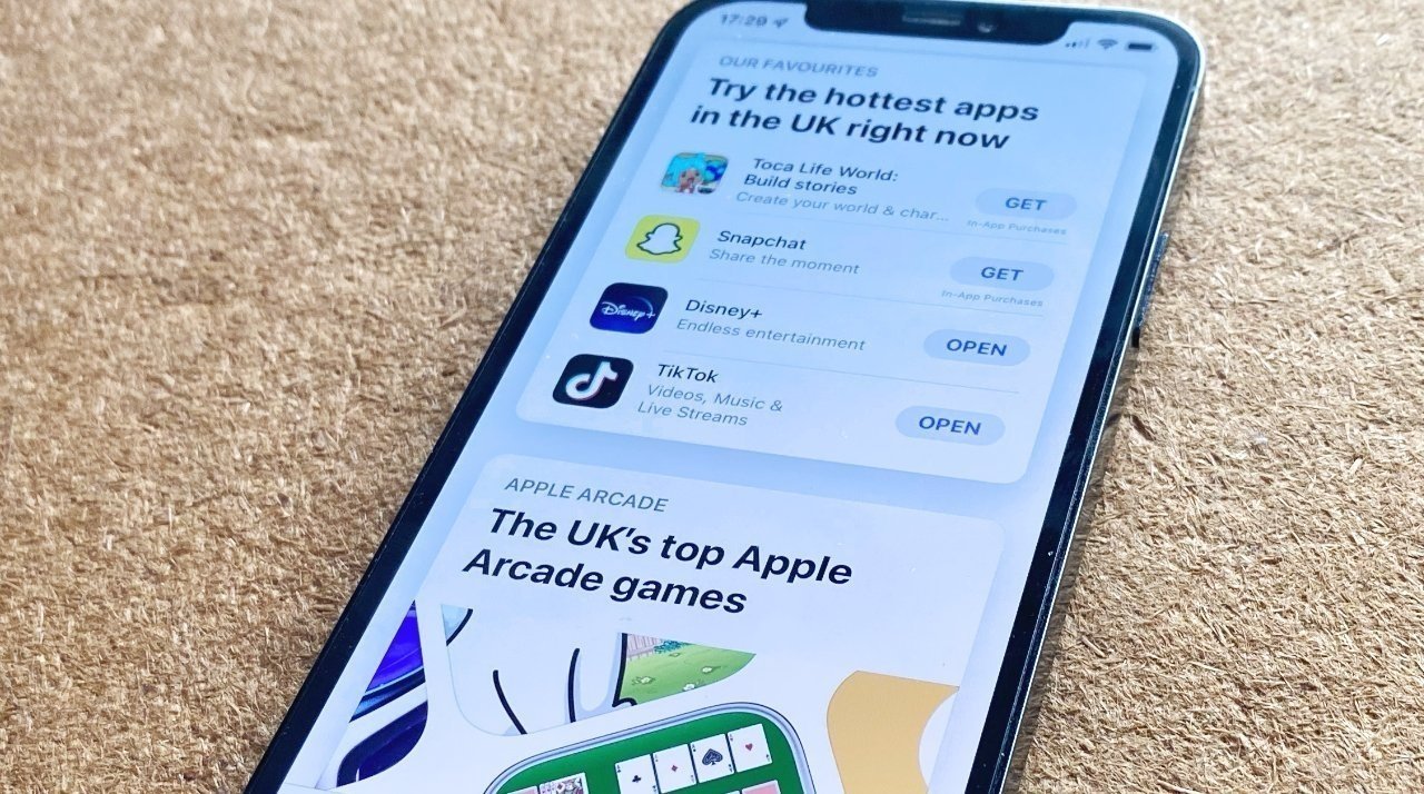 Picture of an iPhone on carpeting with the UK version of the App Store open