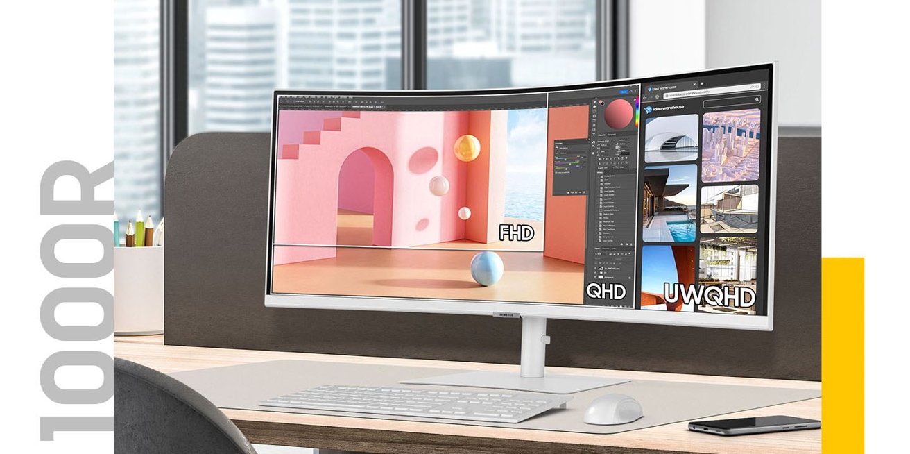Samsung ultrawide curved S6 monitor on a desk with a keyboard, mouse, and smartphone. Screen displays colorful graphics and editing software over a modern office background with windows and buildings.