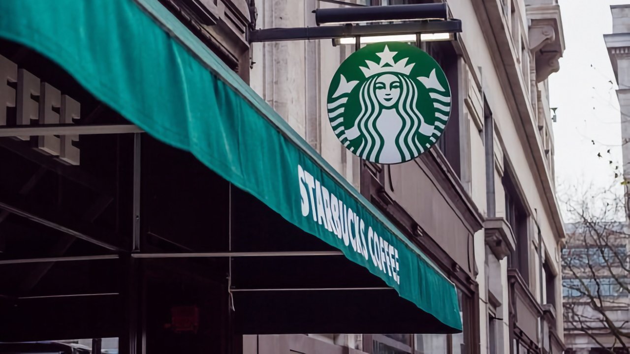 Starbucks storefront with a green awning and circular logo featuring a mermaid.