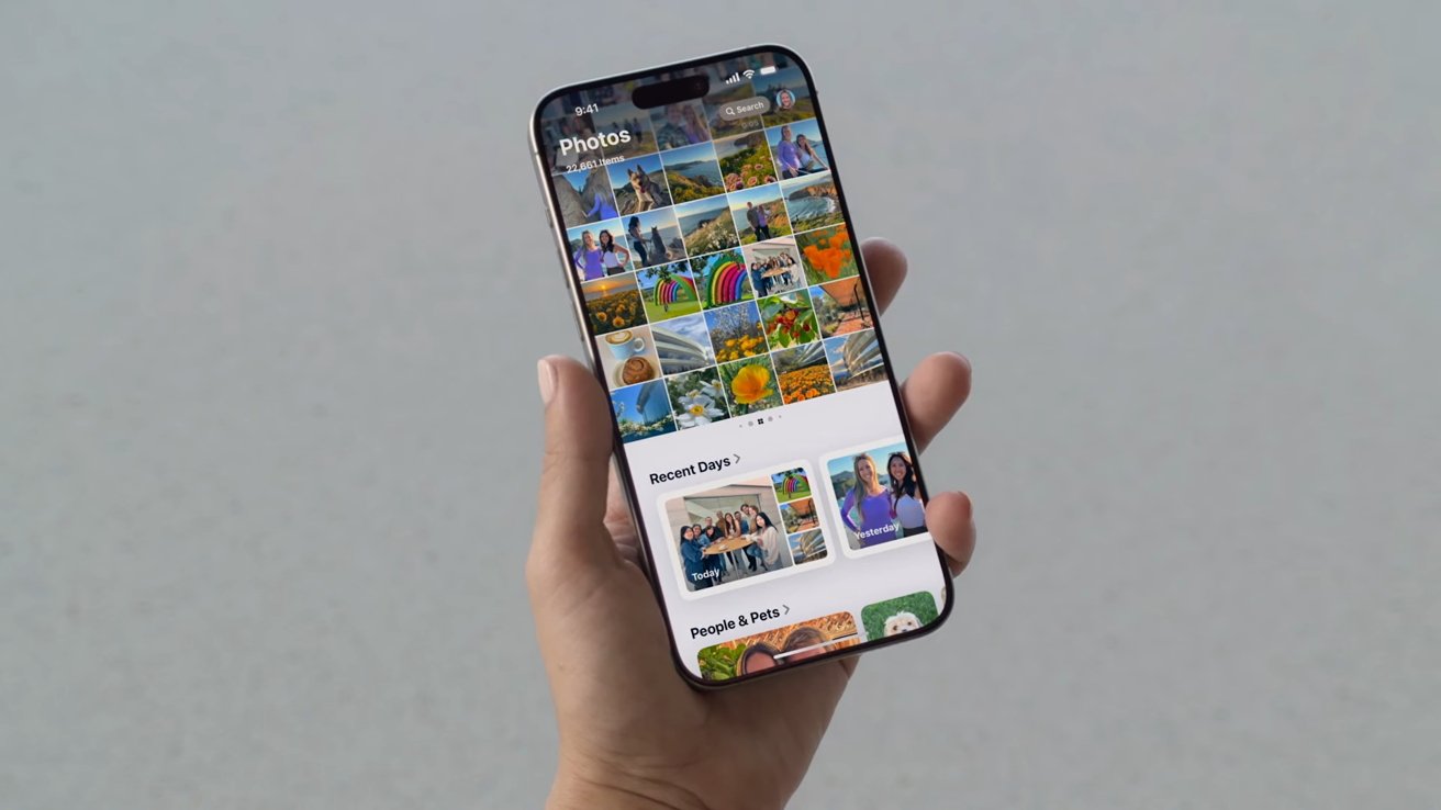 Photos app shown on an iPhone held in a hand
