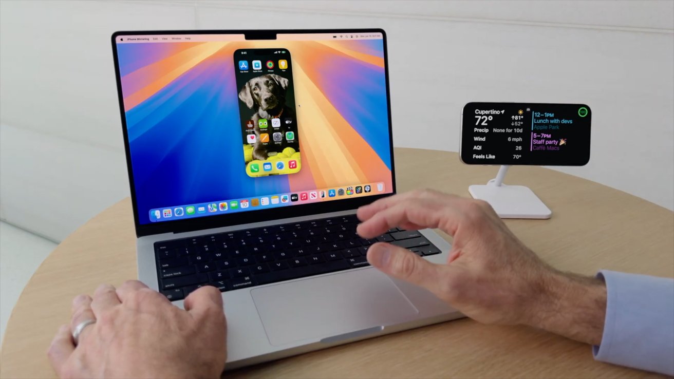 A MacBook Pro with an iPhone mirrored to the display