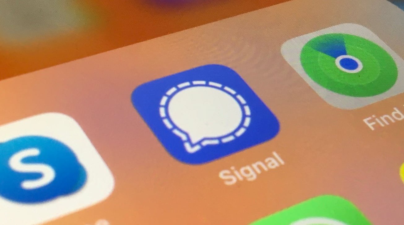 Close-up view of a smartphone screen displaying app icons for Skype, Signal, and Find My.