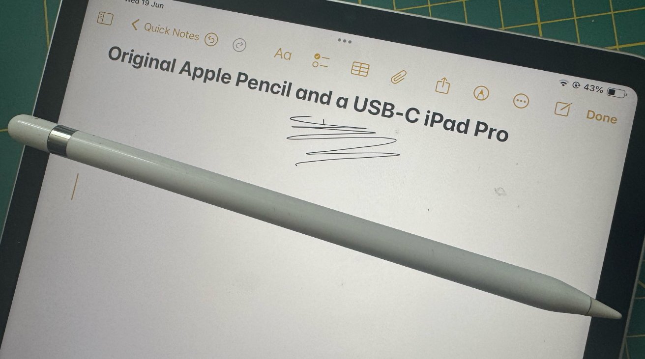 Apple Pencil resting on an iPad screen displaying a note reading 'Original Apple Pencil and USB-C iPad Pro,' with some scribbles below.