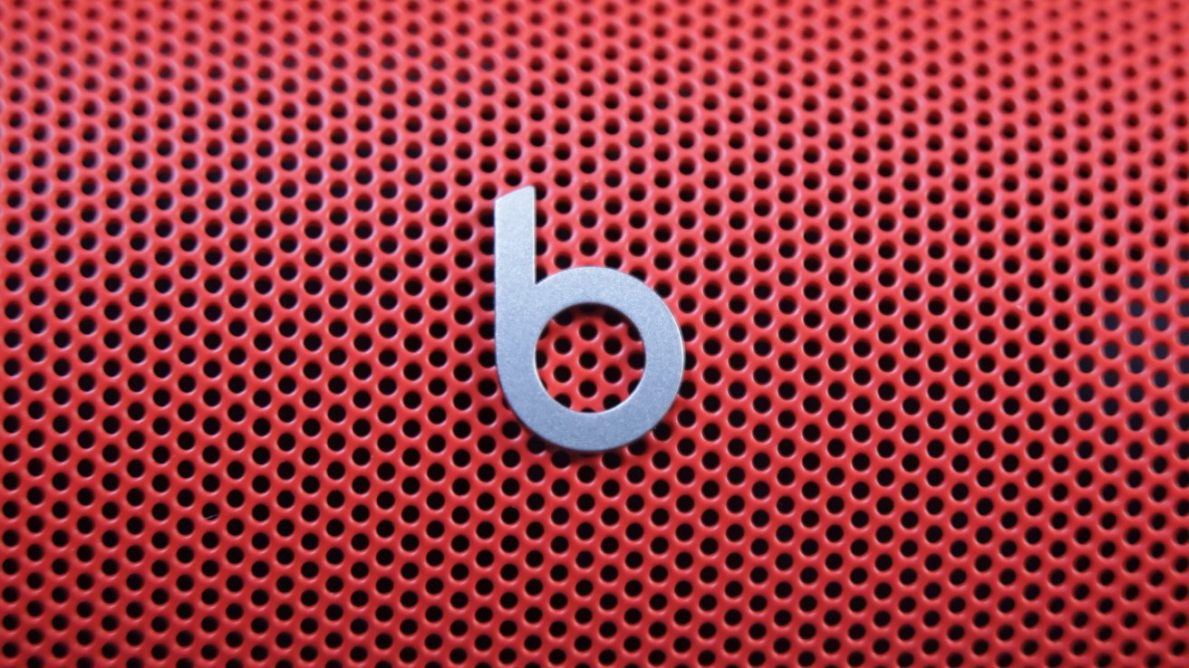 Red perforated surface with a silver lowercase 'b' logo in the center