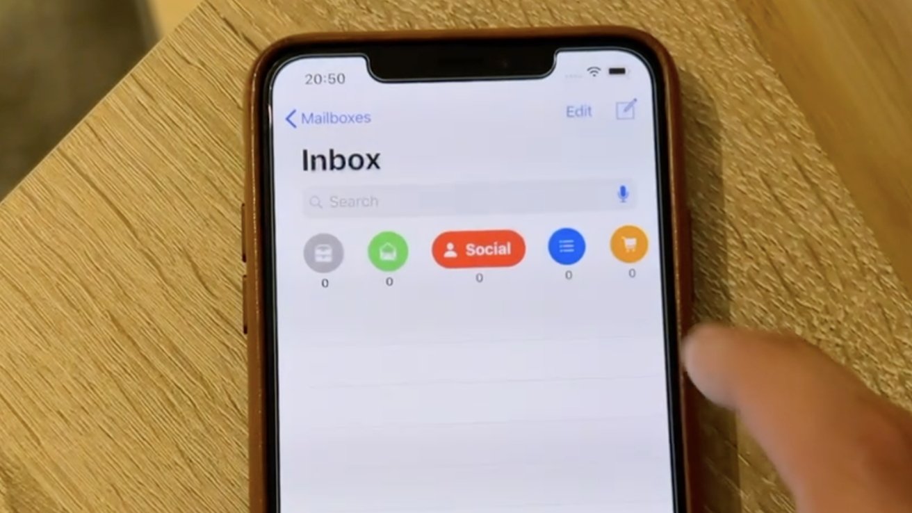 Smartphone screen with Mailboxes showing inbox categories: all mail, primary, social, updates, and promotions, each with zero unread emails. A finger is touching the screen.