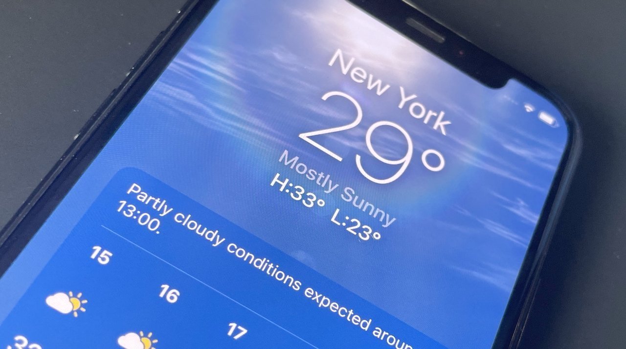 Close-up of a smartphone screen displaying New York's weather: 29 degrees Celsius, mostly sunny, high of 33, low of 23, with partly cloudy conditions expected.