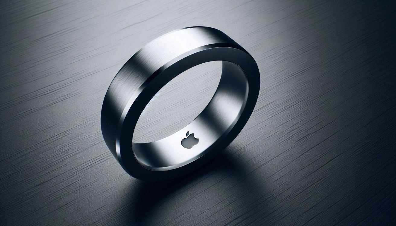 A sleek, silver metallic ring with a smooth finish, featuring a small logo cutout, is placed on a textured dark surface.