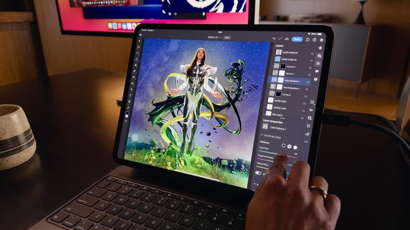 Person editing a sci-fi character artwork on a tablet using a photo editing software, with a hand touching the screen.