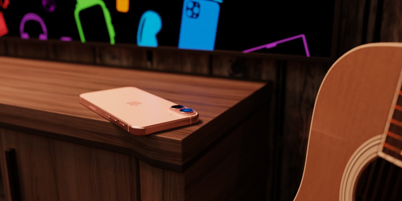 Rose gold phone on a wooden table next to an acoustic guitar, with colorful outlined shapes on a black background in the distance.