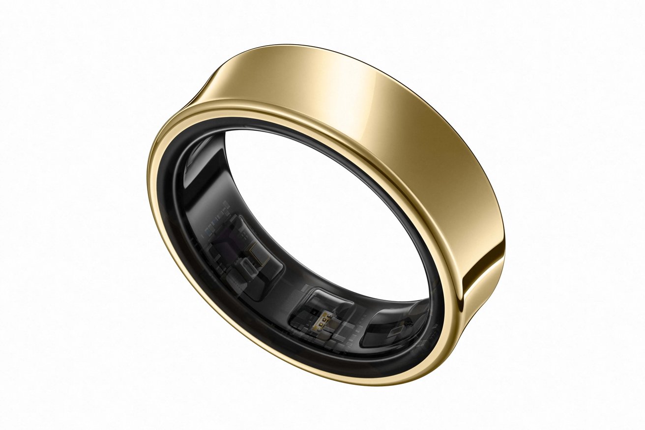 Gold smart ring with sleek design and black interior, containing visible electronic components.