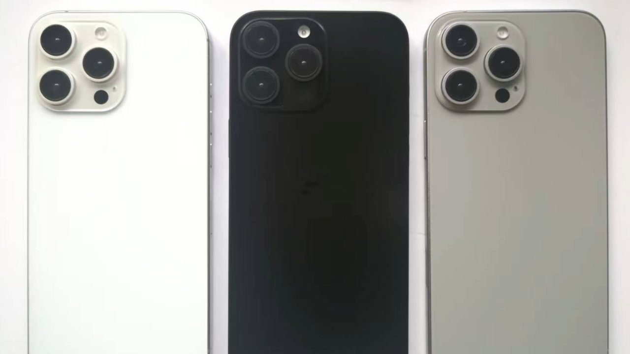 Three smartphones with triple rear cameras: one white, one black, and one gray. They are aligned side by side.