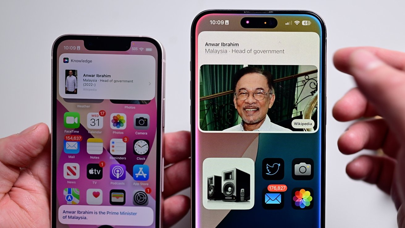 Two searches for the prime minister of Malaysia, comparing the old versus new interfaces on two different iPhones on a white table