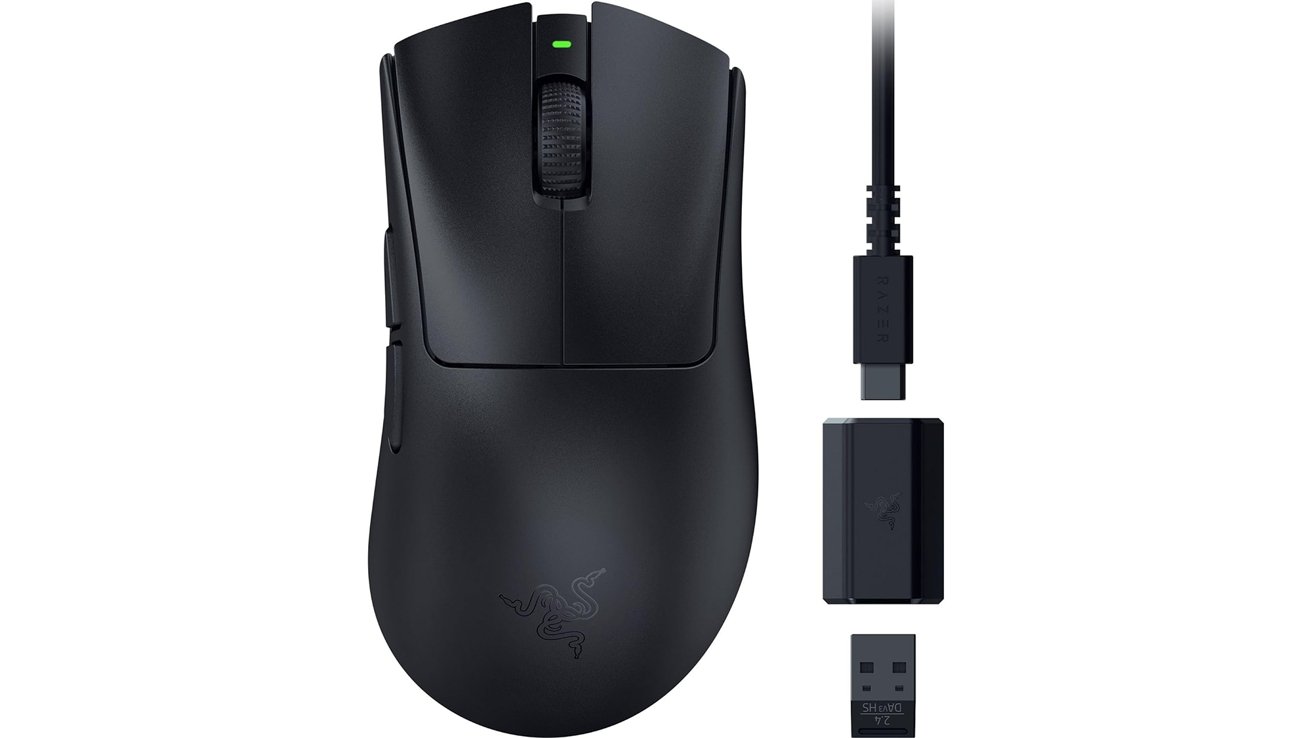 Black wireless computer mouse with green indicator light, accompanied by a charging cable, adapter, and USB receiver.