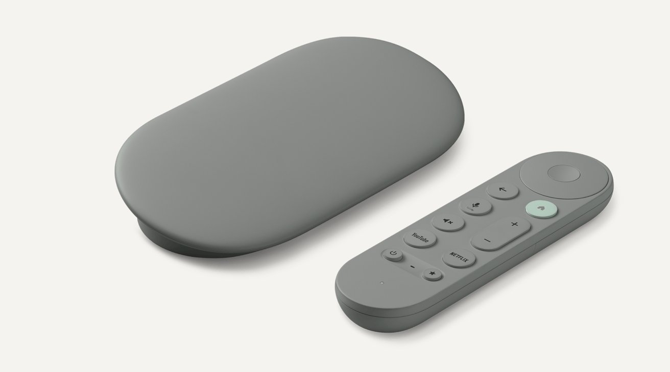 Gray rectangular streaming device with rounded edges alongside a matching gray remote control featuring several buttons.