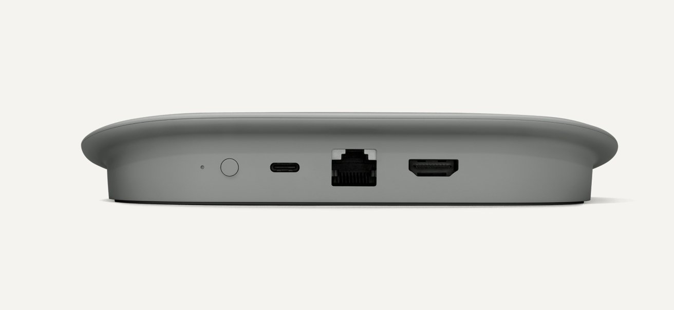 A small, gray electronic device with ports including a power button, USB-C, Ethernet, and HDMI_slots.