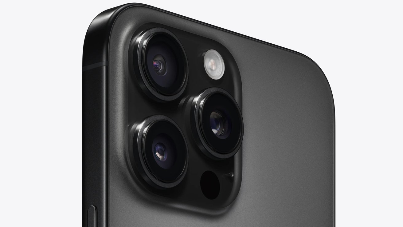 Close-up view of the rear camera setup of a smartphone featuring three lenses and an LED flash on a sleek, dark body.