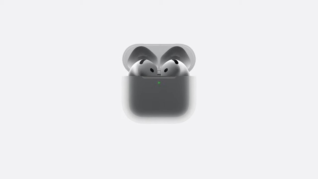 White AirPods 4 in an open charging case with a small green indicator light.