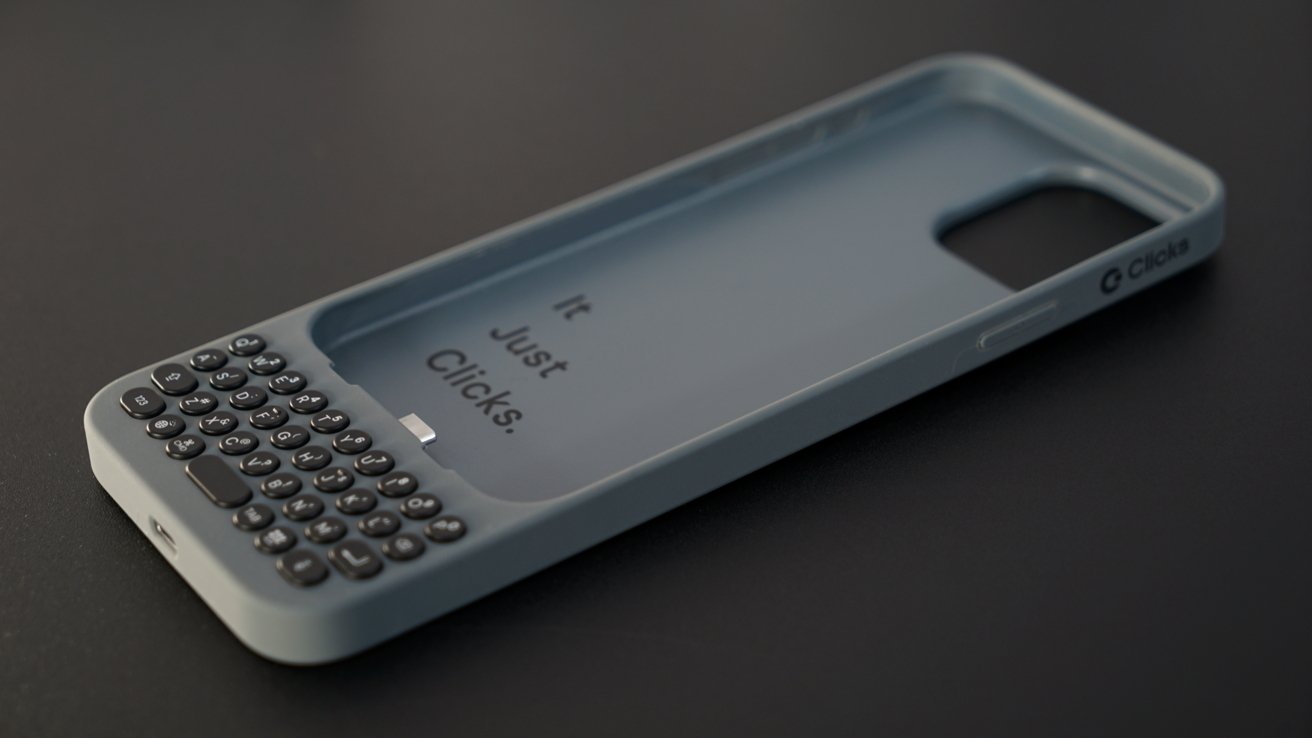 Phone case with built-in physical keyboard, text reads It Just Clicks on the inner surface.