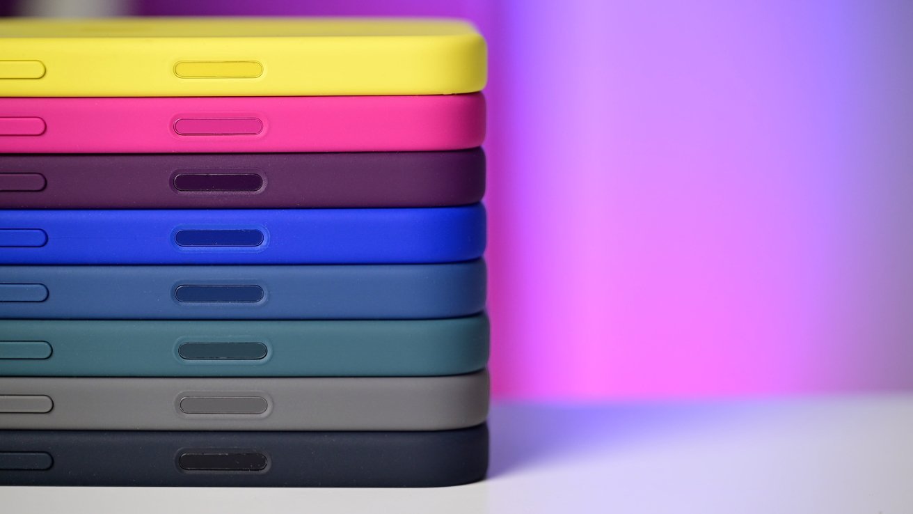 Stacked colorful phone cases against a gradient purple and pink background, showcasing various colors like yellow, pink, blue, and green.