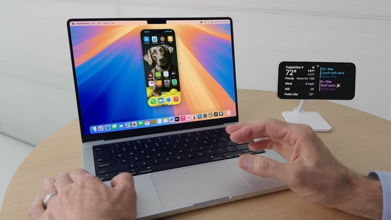 A person interacts with a laptop displaying smartphone mirroring, with a secondary screen on the right showing weather and calendar information.