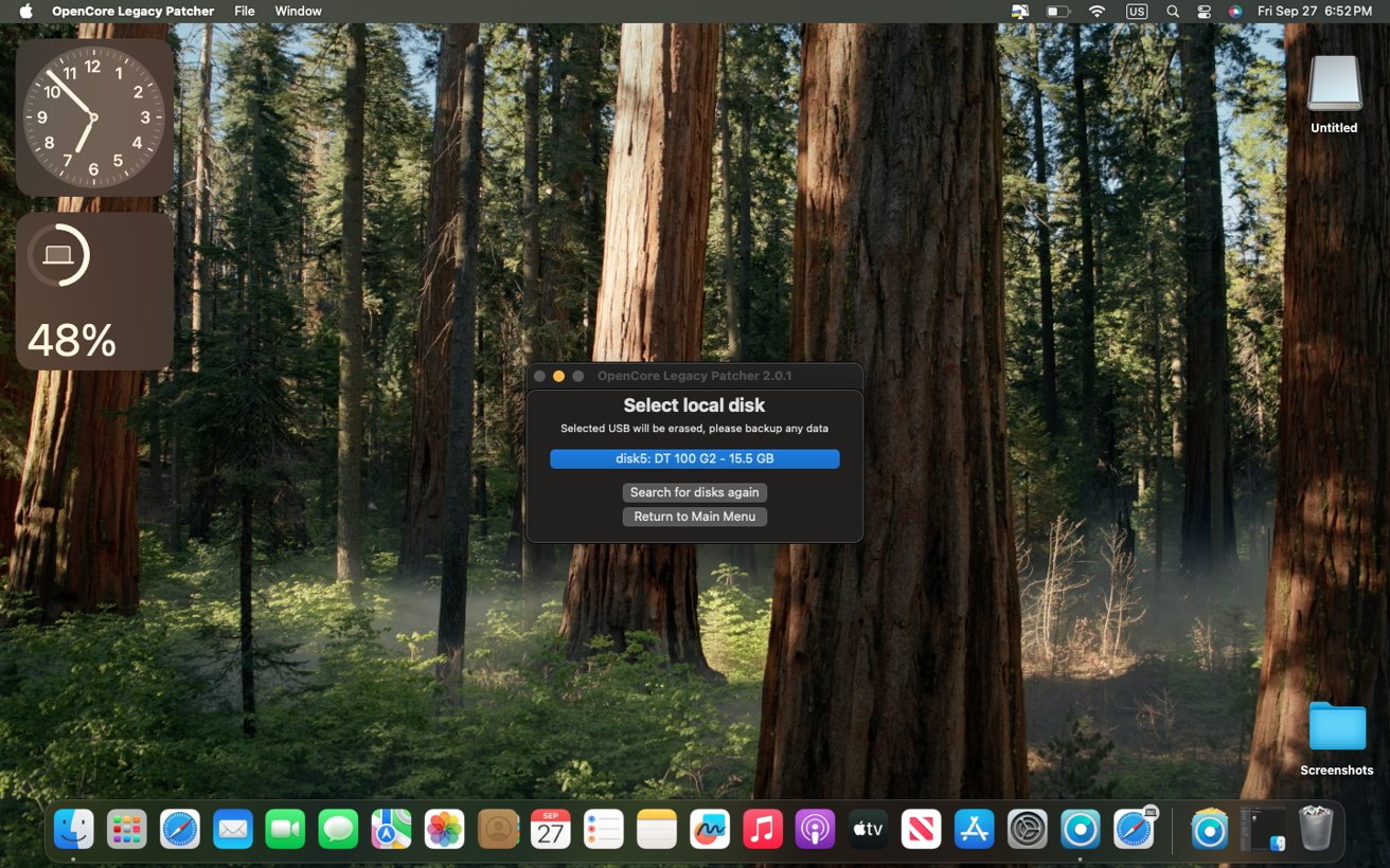 Mac desktop with forest wallpaper, a clock widget, battery indicator at 48%, and a disk selection window in the center. Dock icons are at the bottom.