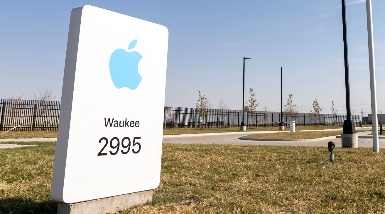 A white sign with blue Apple logo reads Waukee 2995, set against a fenced grassy area with trees and a clear sky.