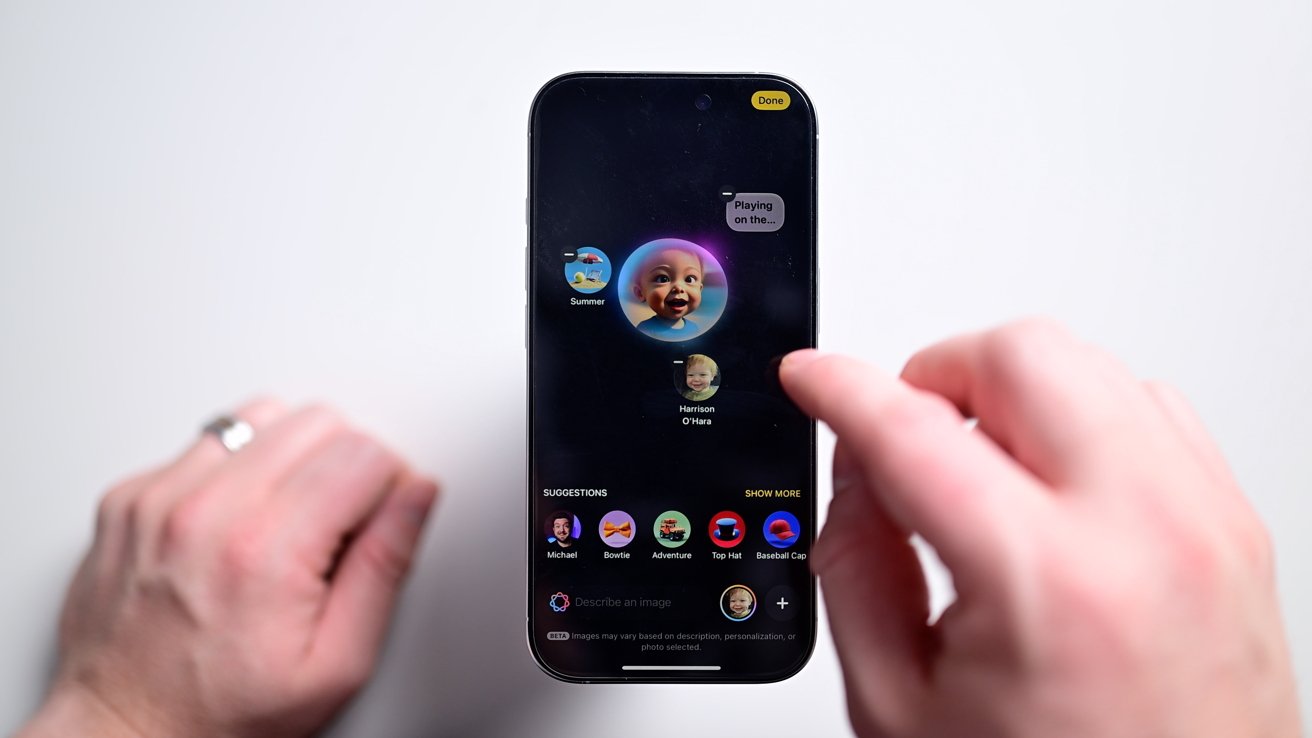 Person holding a smartphone displaying an app with a baby's photo and avatars at the bottom, set against a white background.