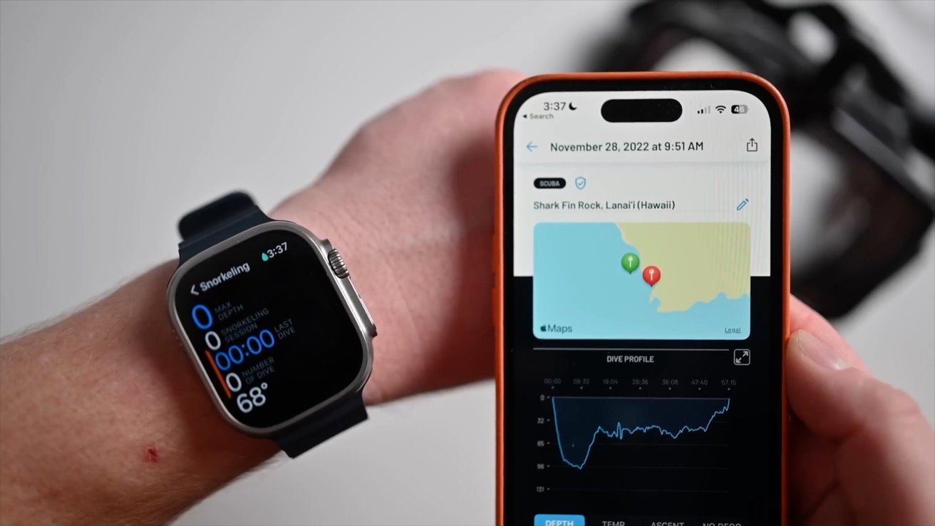 Two smartwatches with black screens and digital crowns, one black and one silver, on a plain white background.