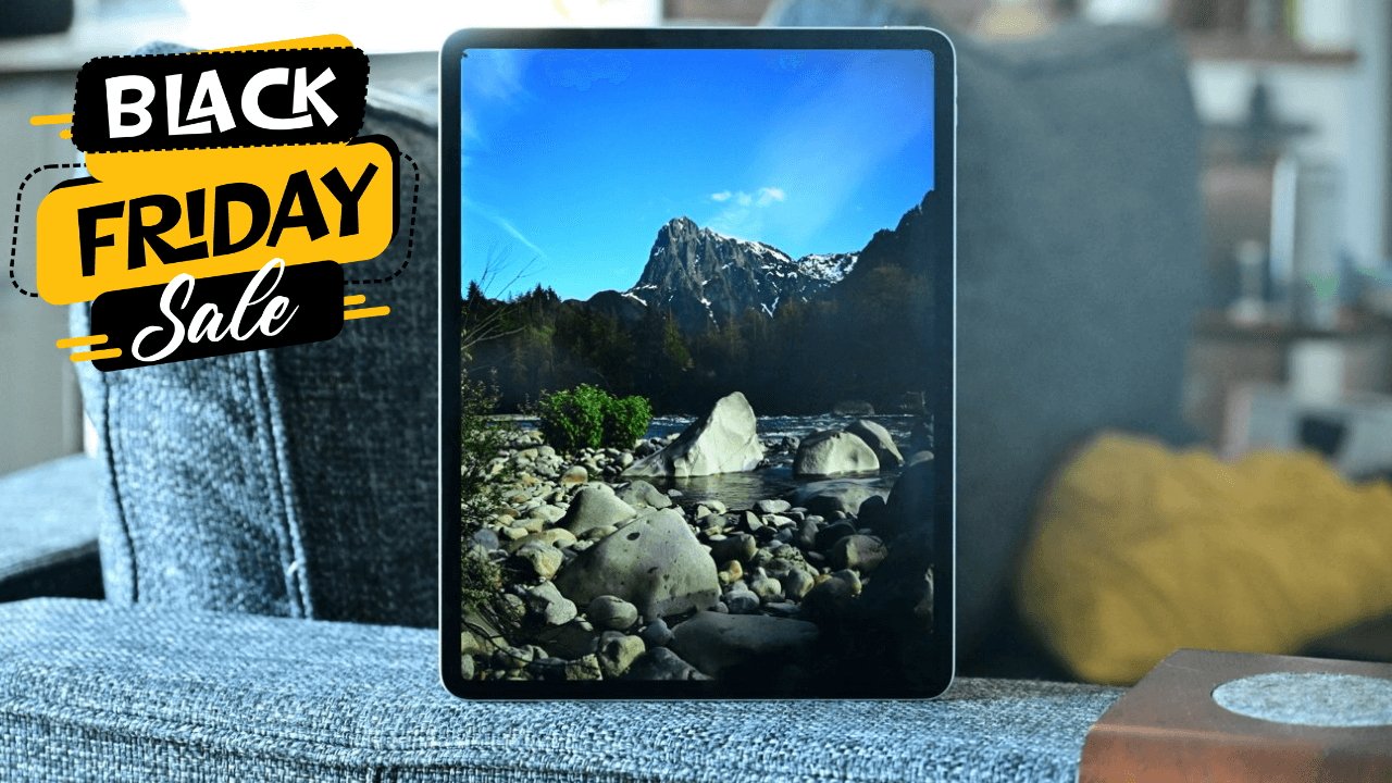 iPad Air tablet displaying a mountain stream scene, resting on a couch with Black Friday Sale text in the corner.