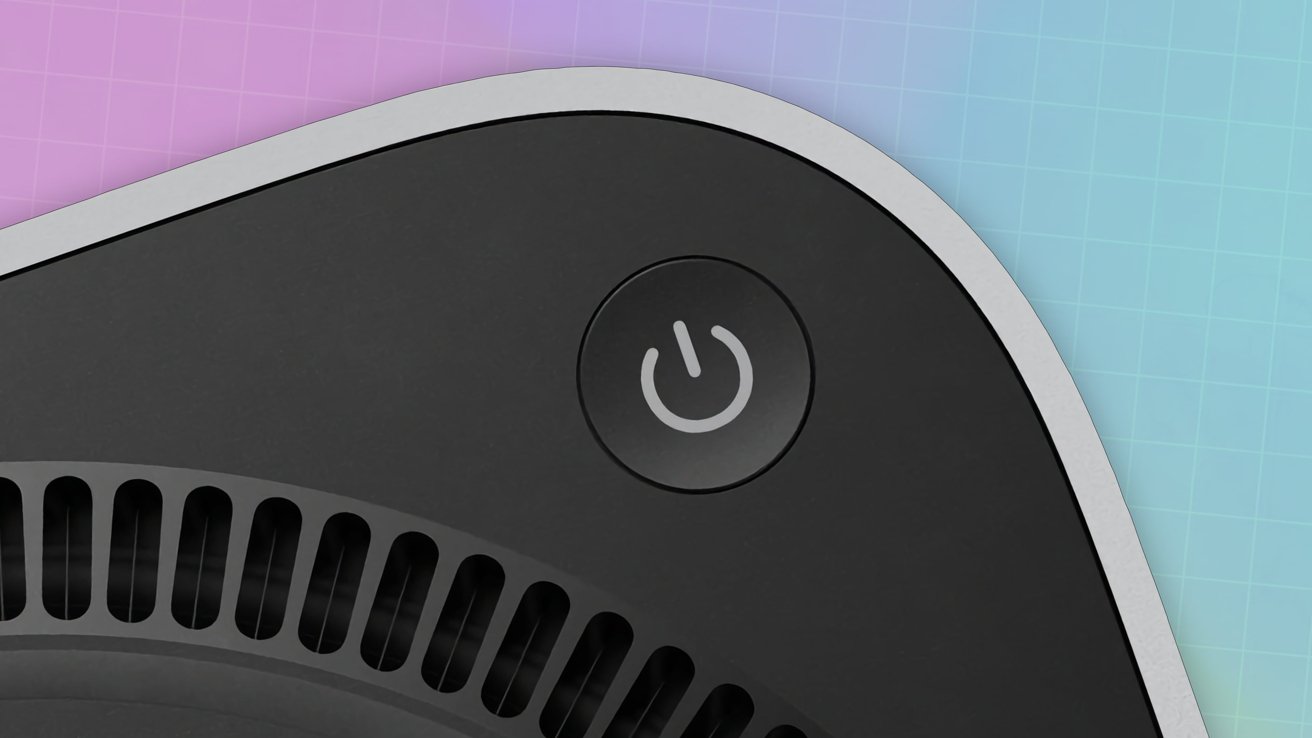 Close-up of a black device with a circular power button on a gradient background featuring pink, blue, and a grid pattern.