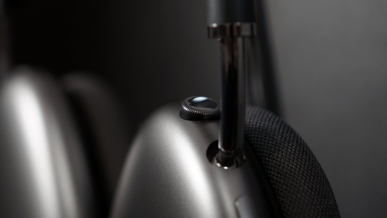 Close-up of a sleek black headphone, highlighting a smooth knob and adjustable headband.